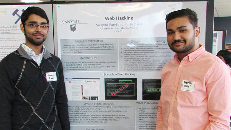 two students with research poster