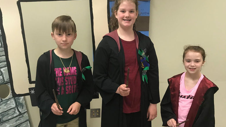 three young children wear capes at Wizard camp