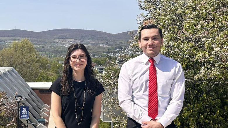 Zamarra and James pose outside for  photo at Penn State Scranton, with mountains in the background