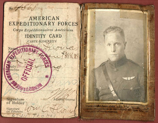 old black and white image of a man in uniform and an old document