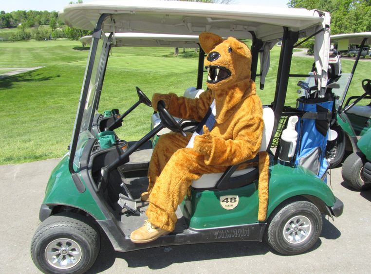 Nittany Lion driving golf cart at last year's tournament