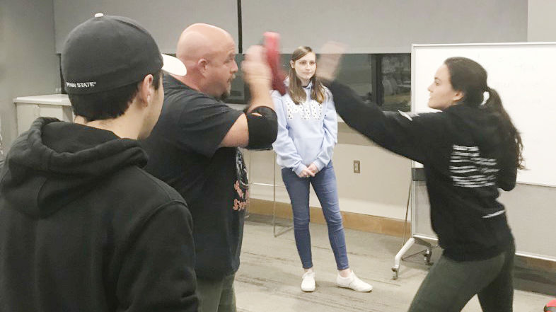 girl punches instructor during self defense class while others watch