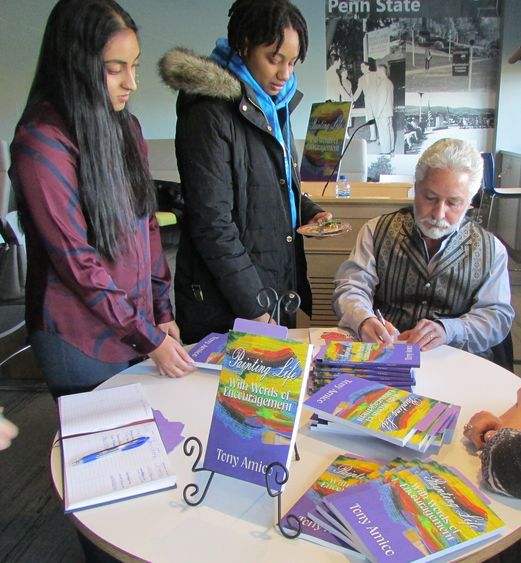 Tony Amico signing books for students