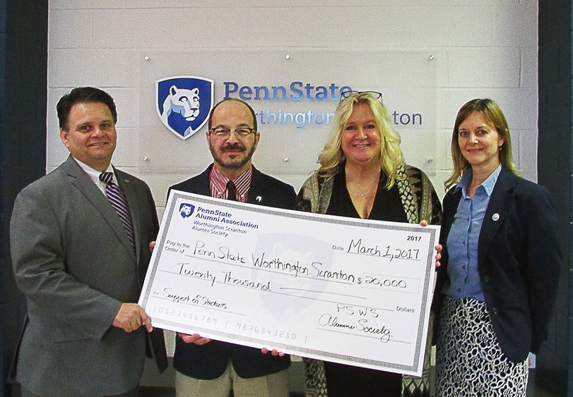 alumni society donatino Alumni society presents check