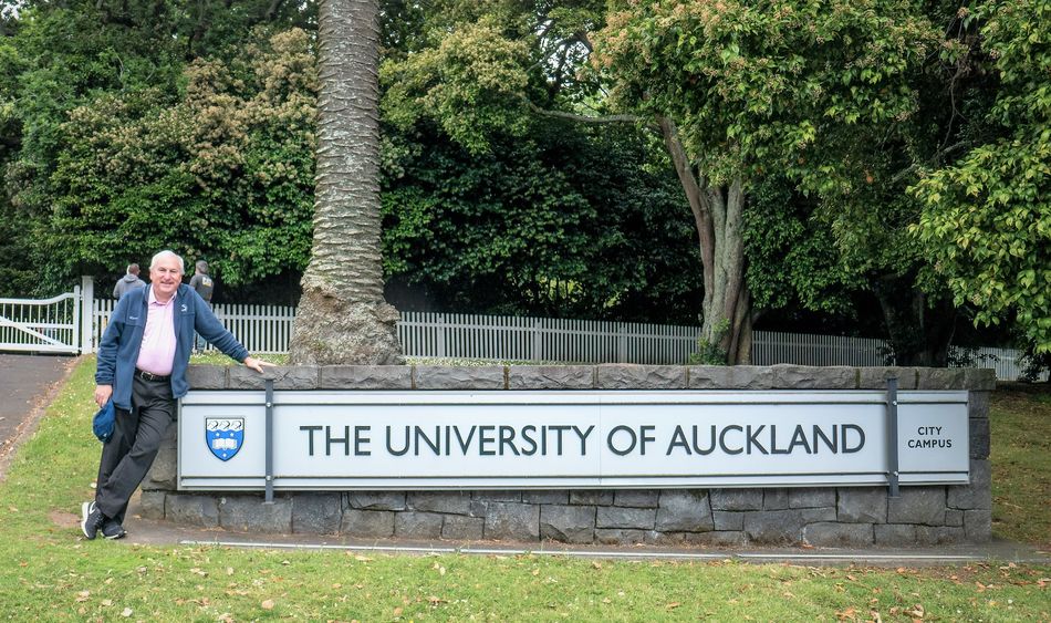 Dr. Alan Peslak at the entrance and sign to the University of Auckland