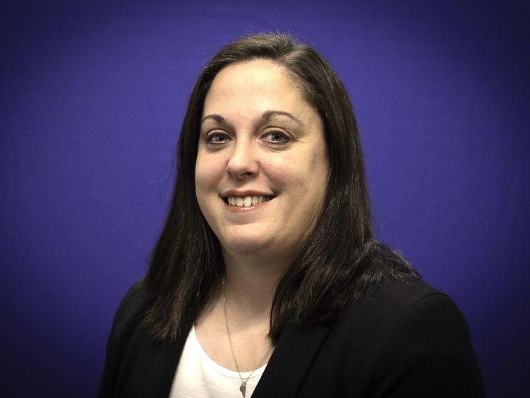 headshot of Blair Cutright with a dark blue background