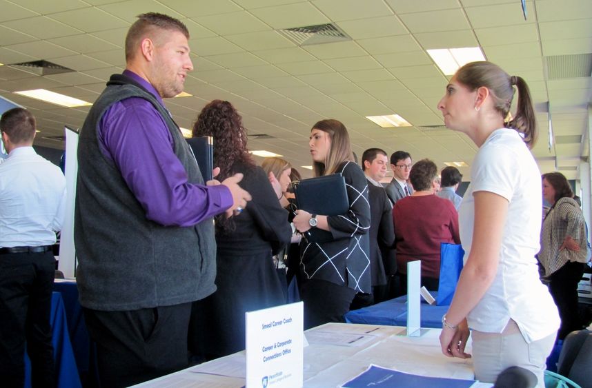 A student attending the Penn State Northeast Region Career Expo talks with a company representative.