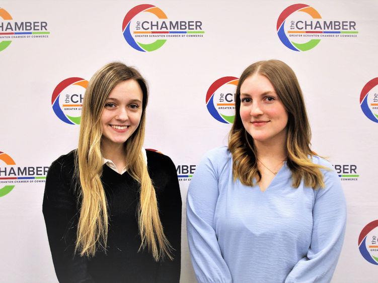 Chamber interns Burdick and Miller posed for photo in front of Scranton Chamber wall
