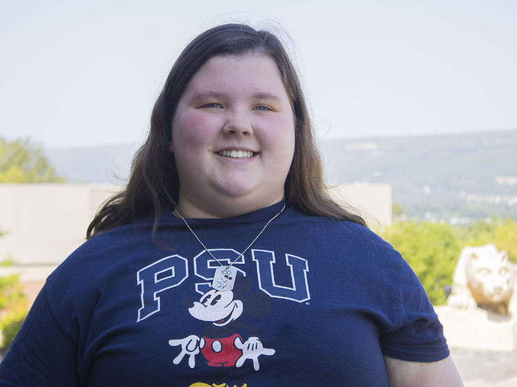 Student smiling wearing a PSU-Disney themed tshirt