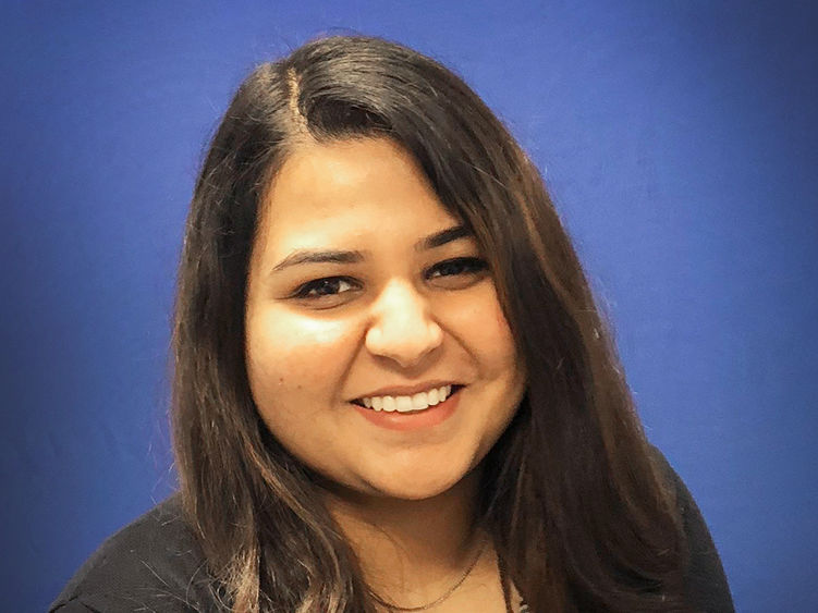 headshot of dharti ray with blue background