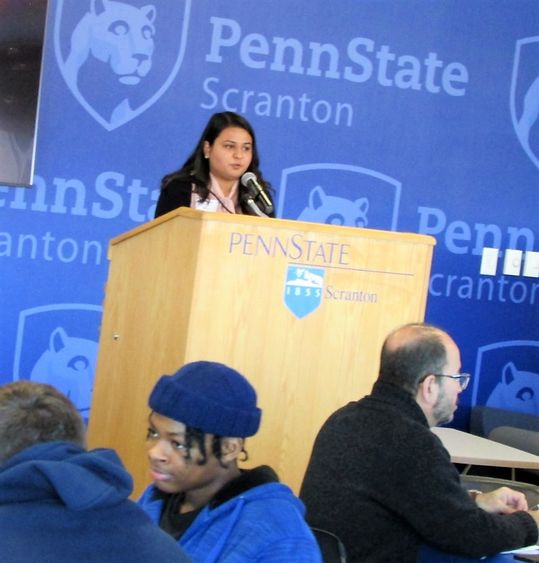 Dharti Ray at the podium welcoming visitors to the MLK event