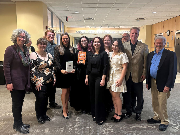 Scranton students and faculty members pose for a group photo with the author