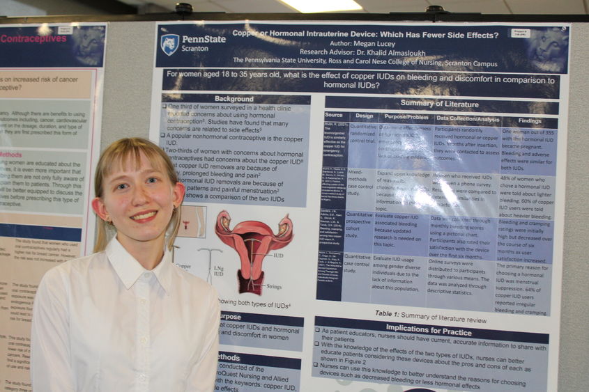 Nursing major Megan Lucey posing in front of her research poster at this year's Penn State Scranton research fair