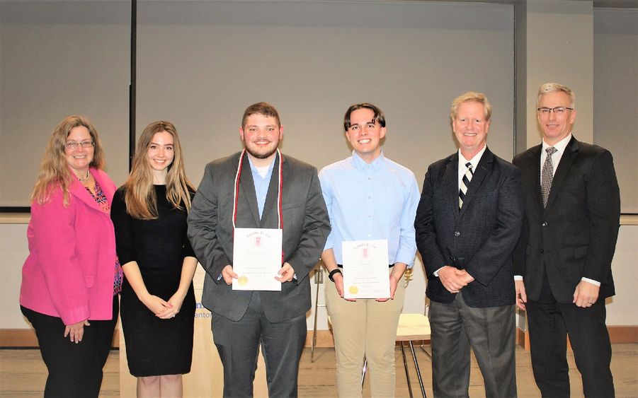 Lambda Pi Eta honor cord recipients pose with faculty members after cording ceremony