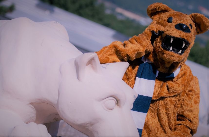 The Nittany Lion standing next to Nittany Lion Shrine