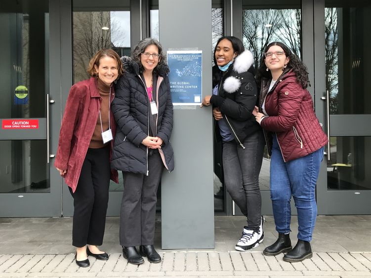 peer tutors with faculty members Jody Griffith and Jaime Mosher pose for a photo in front of conference center