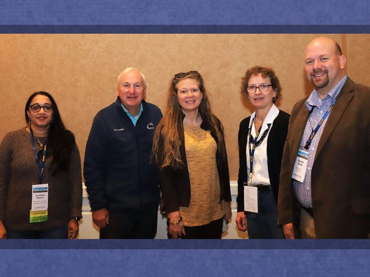 group of professors posing for photo at conference