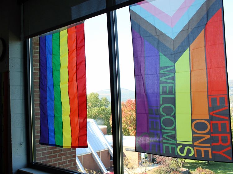 rainbow colored flags hand in the windows of The View Cafe on campus