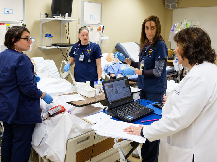 group of nurses receiving instruction in nursing sim lab