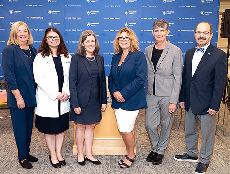 university administrators pose for a group photo prior to ribbon cutting