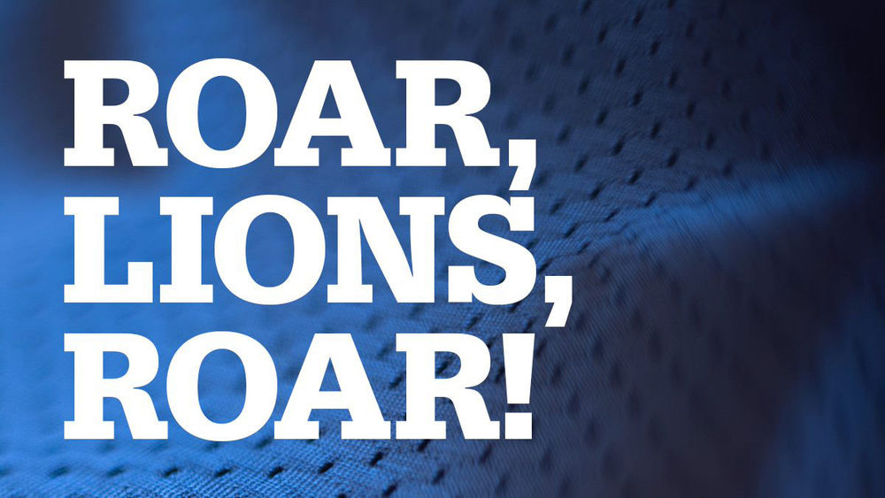 blue fabric background with roar lions roar written on it