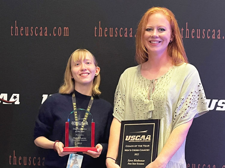 Megan Lucy and Sara Rinkunas holding their awards at USCAA awards ceremony