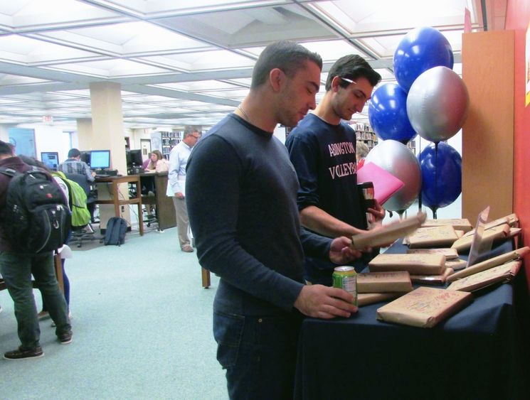 Students select books from a display of 'banned' reading material