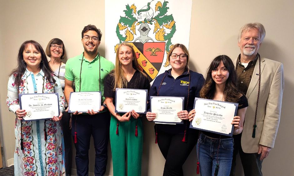 new beta beta beta inductees pose for a photo holding their membership certificates