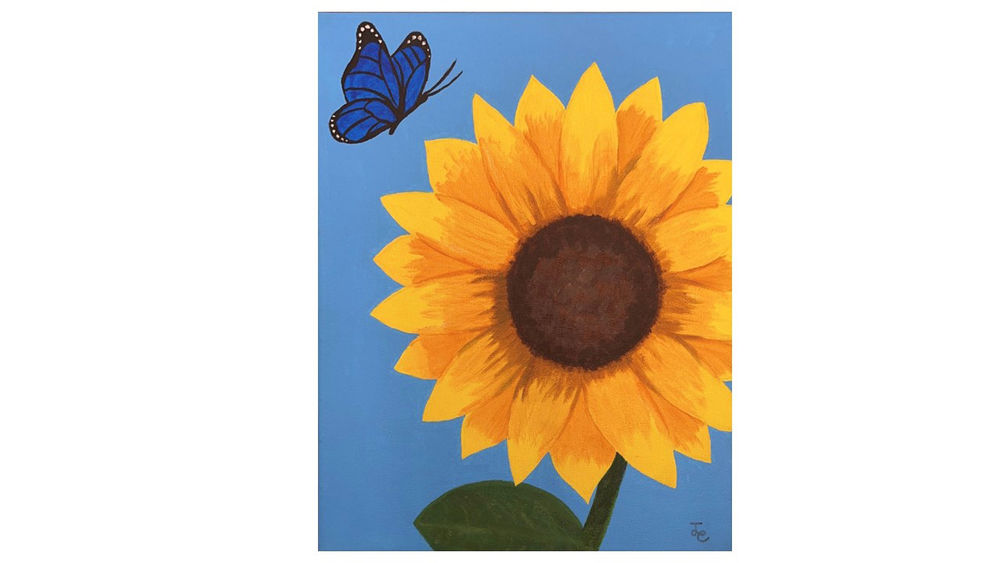 Sunflower on a painted blue background with a butterfly hovering in upper left corner