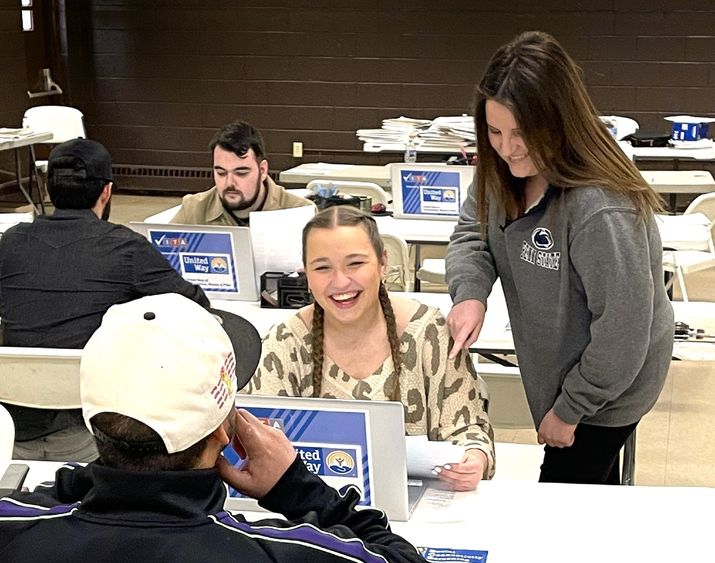 professor angela bassani assists a student during a volunteer session at VITA