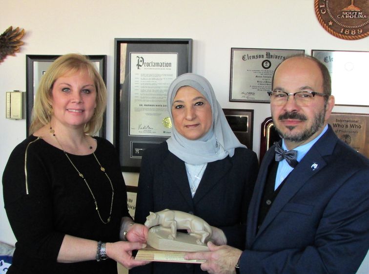 Dr. Wafa and wife receiving lion shrine statue