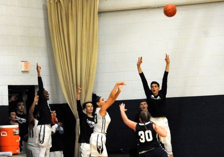 Monique Hicks throwing basketball over York guard