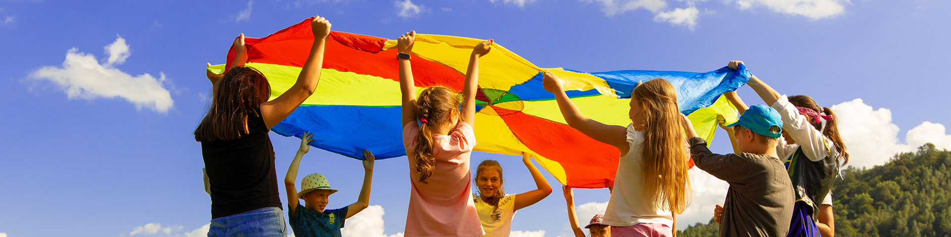 group of kids with a colorful parachute Photo by Artem Kniaz on Unsplash
